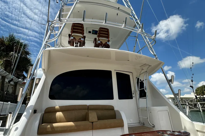 Slide: The Image of 2017 Viking 55 Convertible yacht with flybridge, docked under a clear blue sky. - 59
