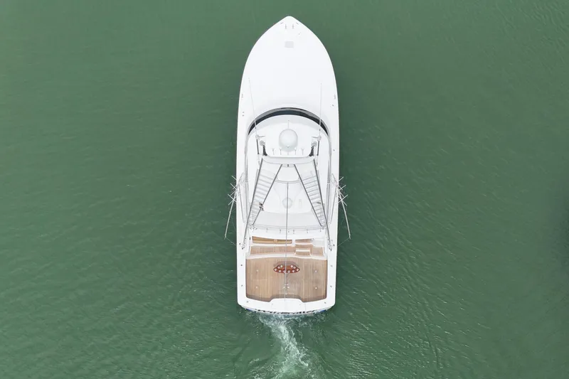 Slide: The Image of Aerial view of 2017 Viking 55 Convertible yacht cruising on green water. - 6