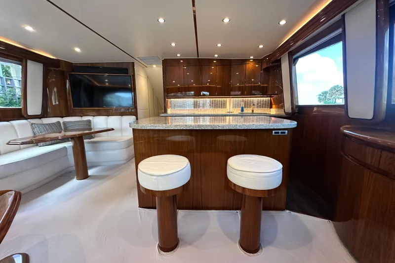 Slide: The Image of Luxurious interior of a 2017 Viking 55 Convertible yacht with modern kitchen and seating area. - 63
