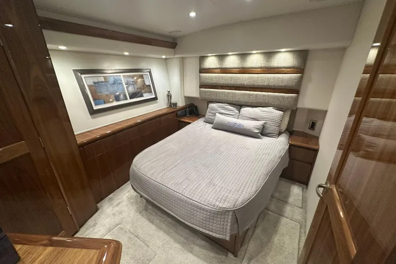 Slide: The Image of Luxurious bedroom interior of 2017 Viking 55 Convertible yacht with elegant wood finishes. - 87