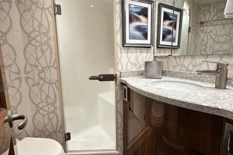 Slide: The Image of Luxurious bathroom in 2017 Viking 55 Convertible yacht with modern fixtures and elegant decor. - 96