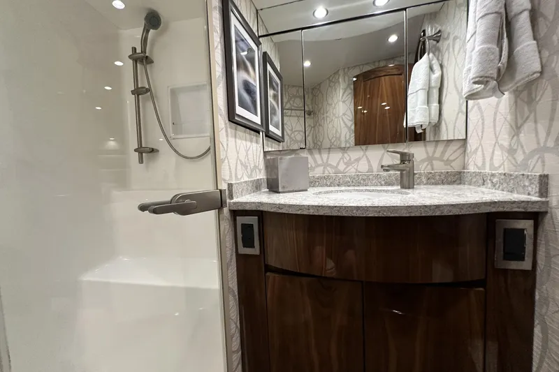Slide: The Image of Luxurious bathroom in 2017 Viking 55 Convertible yacht with modern fixtures and elegant design. - 98
