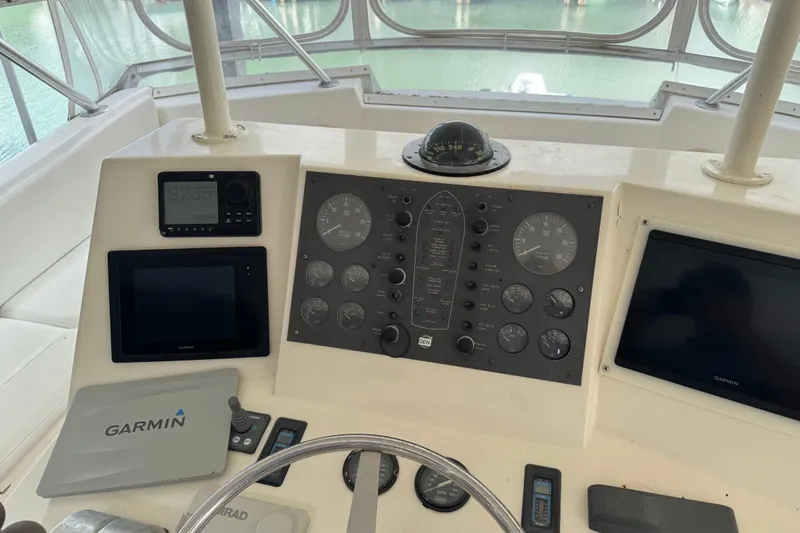 Slide: The Image of Control panel of a 1993 Viking 50 Convertible boat with Garmin navigation equipment. - 11