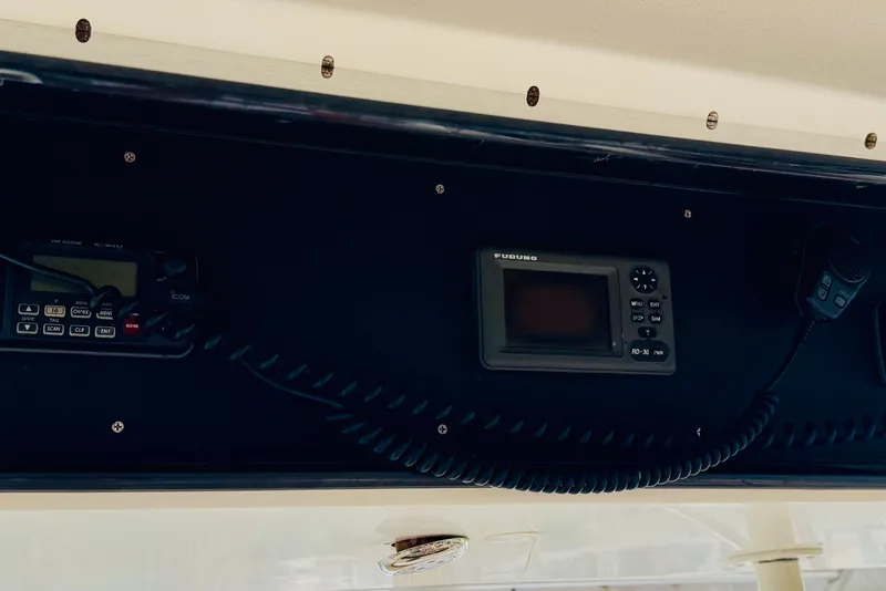 Slide: The Image of Control panel of a 1993 Viking 50 Convertible boat with communication devices. - 12