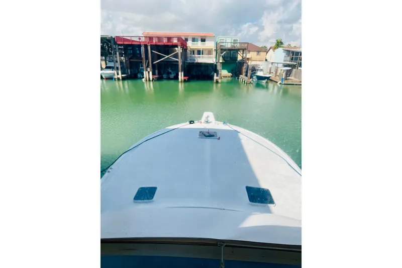Slide: The Image of Bow view of 1993 Viking 50 Convertible yacht docked in a marina. - 14