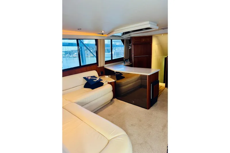 Slide: The Image of Interior of 1993 Viking 50 Convertible yacht with cream leather seating and wooden cabinetry. - 23