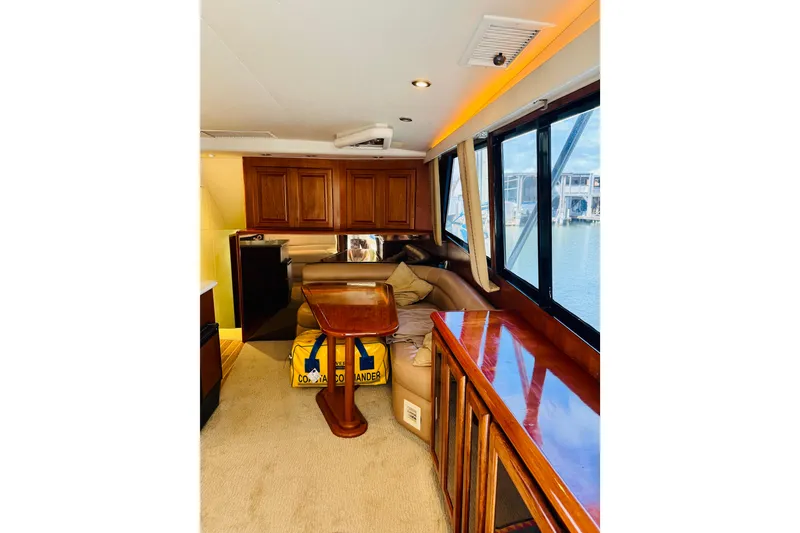 Slide: The Image of Interior of 1993 Viking 50 Convertible yacht with wooden cabinetry and large windows. - 24