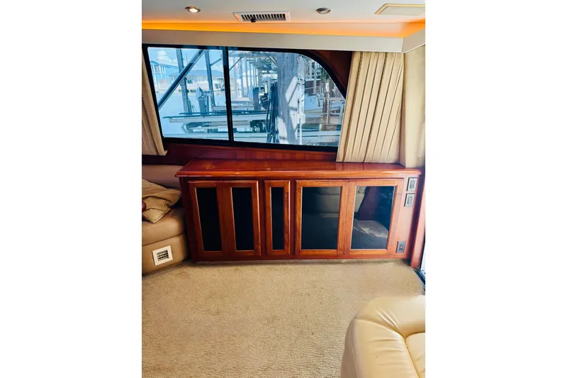 Slide: The Image of Interior of 1993 Viking 50 Convertible yacht with wooden cabinetry and large window. - 25