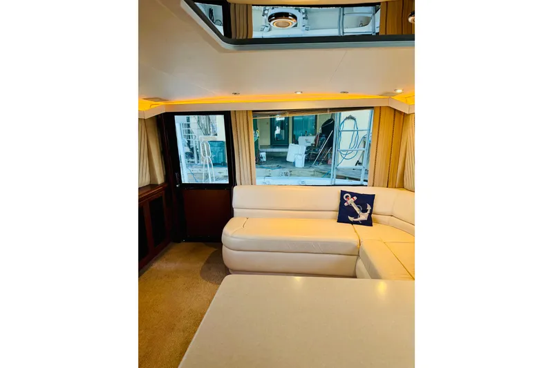 Slide: The Image of Interior of 1993 Viking 50 Convertible yacht with cream leather seating and anchor-themed pillow. - 26