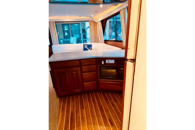 Slide: The Image of Interior of 1993 Viking 50 Convertible yacht with wood flooring and modern kitchen amenities. - 27