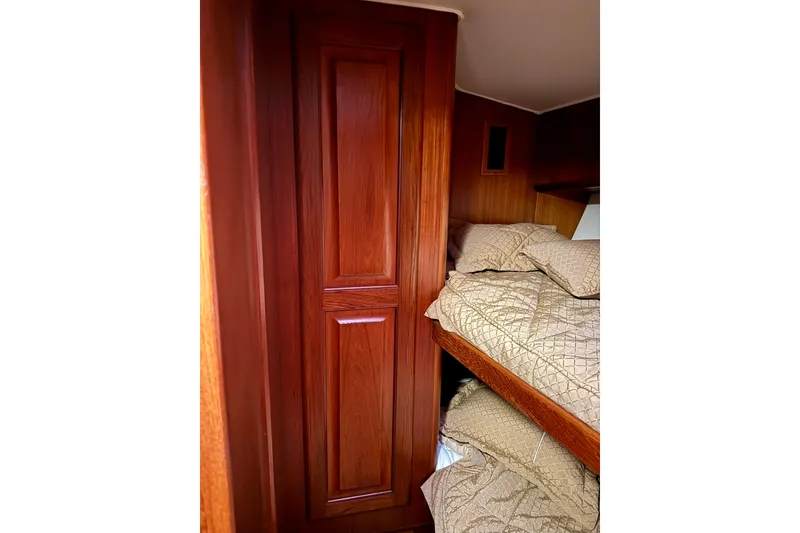 Slide: The Image of Interior of 1993 Viking 50 Convertible yacht with wooden cabinetry and cozy bunk beds. - 32