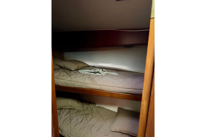 Slide: The Image of Bunk beds in 1993 Viking 50 Convertible yacht cabin with brown bedding. - 33