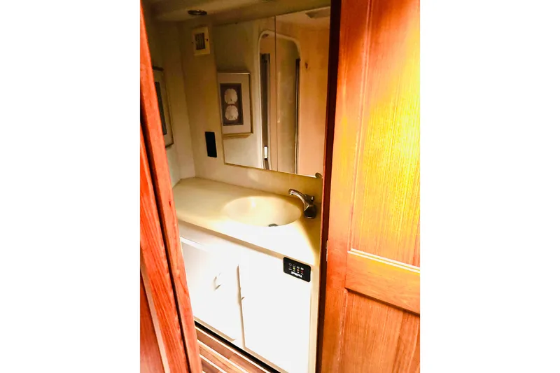 Slide: The Image of Bathroom interior of 1993 Viking 50 Convertible yacht with sink and mirror. - 34