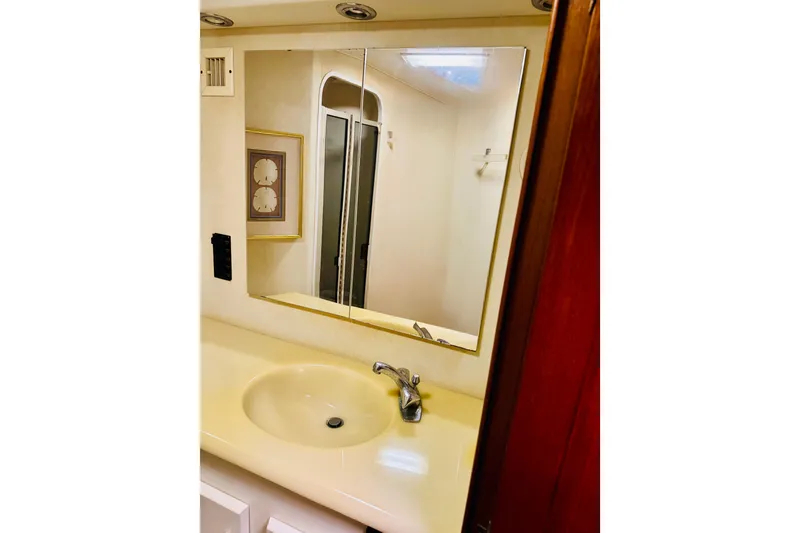 Slide: The Image of Bathroom vanity with mirror in 1993 Viking 50 Convertible yacht. - 37