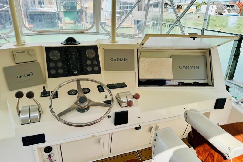 Slide: The Image of 1993 Viking 50 Convertible helm with Garmin navigation and steering wheel. - 8