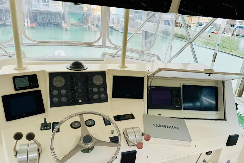 Slide: The Image of Cockpit of 1993 Viking 50 Convertible yacht with navigation instruments and steering wheel. - 9