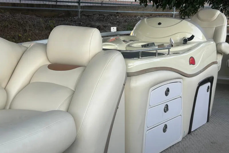 Slide: The Image of 2011 SUNTRACKER PARTY BARGE 22 REGENCY EDITION interior with plush seating and control panel. - 13