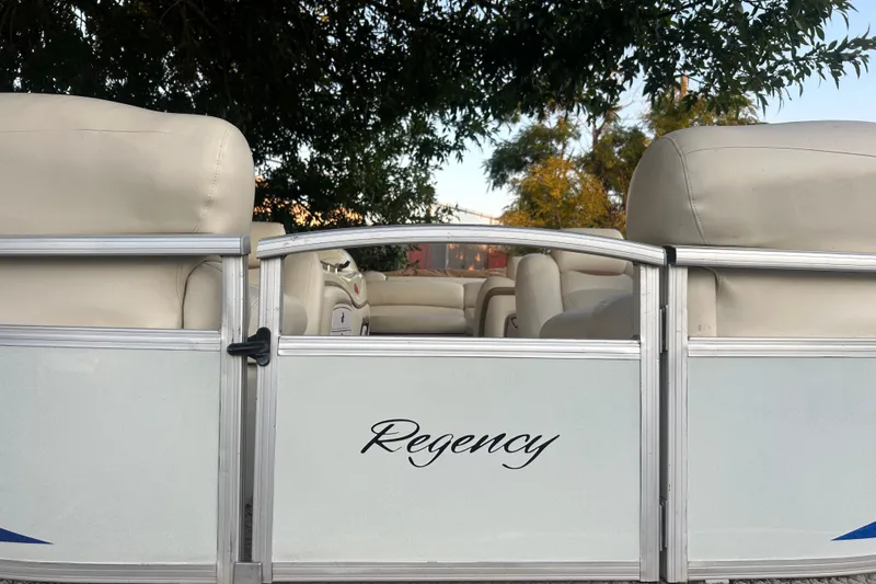 Slide: The Image of 2011 SUNTRACKER PARTY BARGE 22 REGENCY EDITION with beige seating and "Regency" logo. - 17