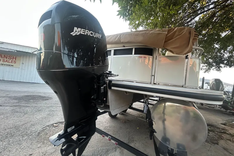 Slide: The Image of 2011 SUNTRACKER PARTY BARGE 22 REGENCY EDITION with Mercury outboard motor on trailer. - 3