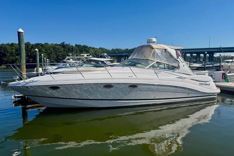 The Image of 2005 Four Winns 348 Vista boat docked in a marina under clear blue skies. - 0