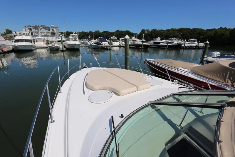 Slide: The Image of 2005 Four Winns 348 Vista yacht docked at marina with other boats. - 12