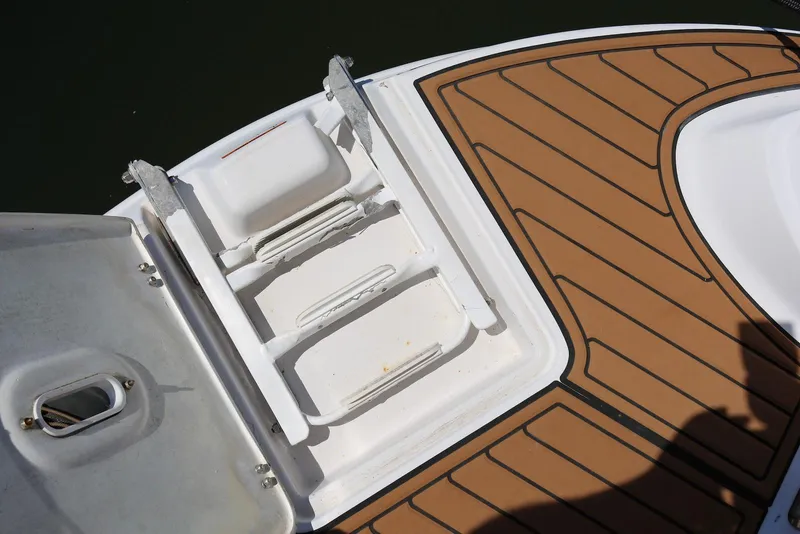 Slide: The Image of 2005 Four Winns 348 Vista boat deck with swim ladder and teak-style flooring. - 16
