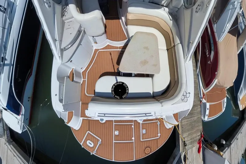 Slide: The Image of 2005 Four Winns 348 Vista boat interior with seating and table, docked at marina. - 17