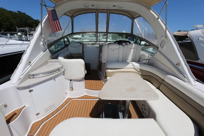 Slide: The Image of 2005 Four Winns 348 Vista boat interior with seating and table, featuring sleek design. - 20