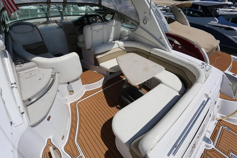 Slide: The Image of 2005 Four Winns 348 Vista boat interior with seating and table on teak deck. - 21