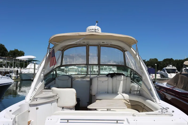 Slide: The Image of 2005 Four Winns 348 Vista boat docked, featuring spacious seating and canopy. - 24