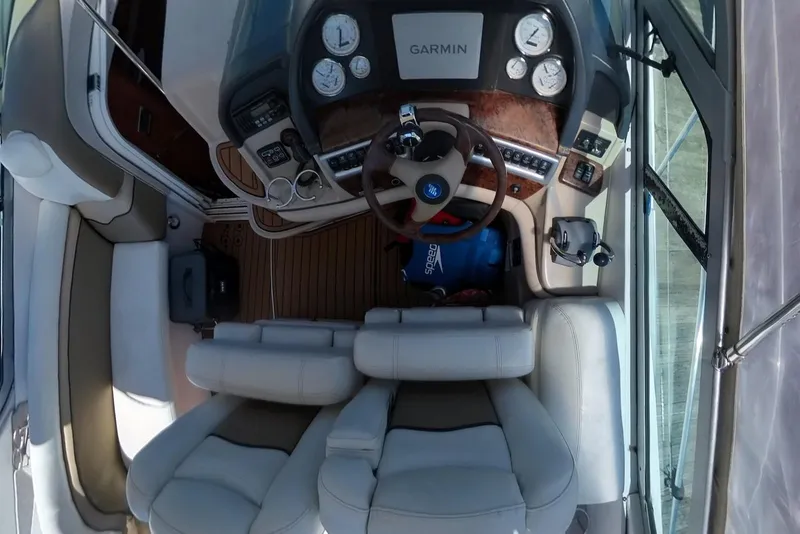 Slide: The Image of 2005 Four Winns 348 Vista boat cockpit with Garmin navigation system and leather seating. - 26