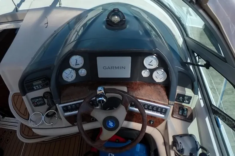 Slide: The Image of 2005 Four Winns 348 Vista helm with Garmin navigation and wood-accented steering wheel. - 29