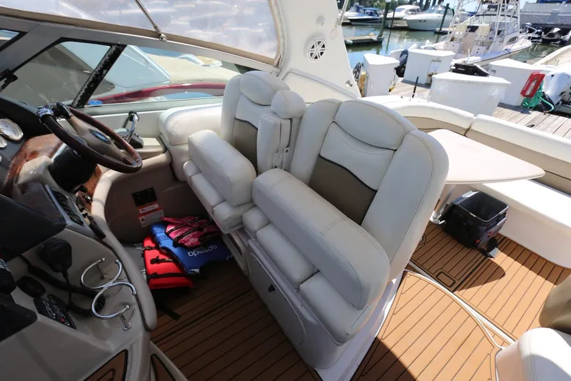 Slide: The Image of 2005 Four Winns 348 Vista boat interior with helm, seating, and life jackets. - 31