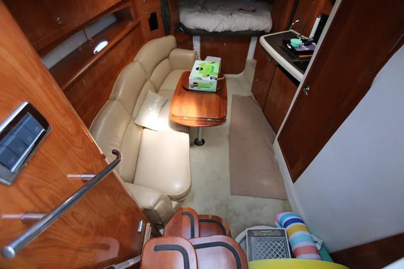 Slide: The Image of Interior of 2005 Four Winns 348 Vista yacht with seating, table, and kitchenette. - 32