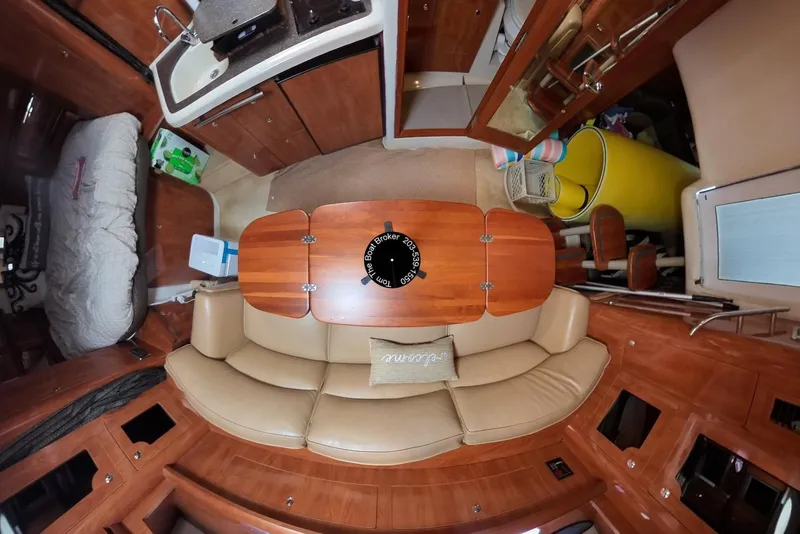 Slide: The Image of Interior of 2005 Four Winns 348 Vista boat with leather seating and wooden table. - 33