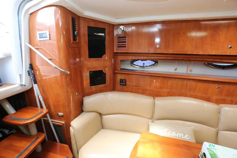 Slide: The Image of Interior of 2005 Four Winns 348 Vista yacht with wood cabinetry and beige seating. - 34