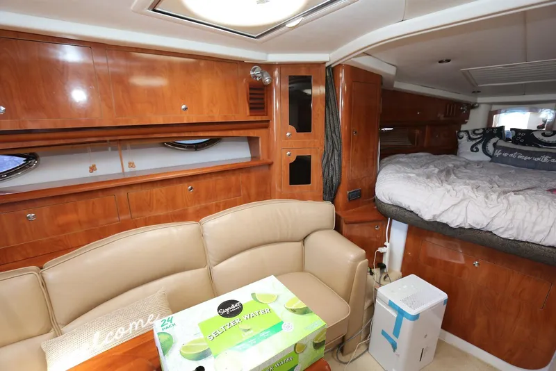 Slide: The Image of Interior of 2005 Four Winns 348 Vista yacht with wood cabinetry and cozy seating area. - 35