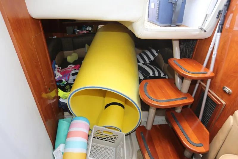 Slide: The Image of Interior of 2005 Four Winns 348 Vista boat with colorful pool floats and wooden steps. - 37