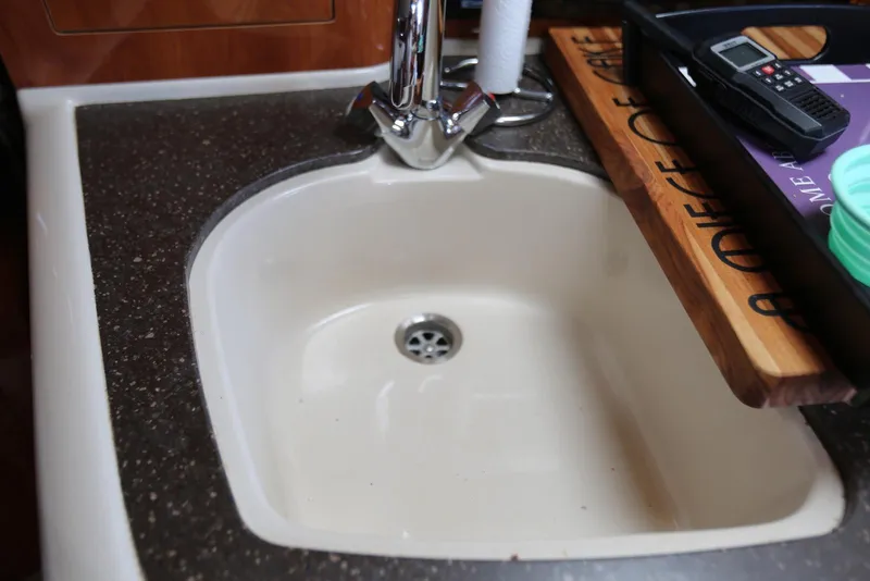 Slide: The Image of Sink area in 2005 Four Winns 348 Vista boat kitchen with faucet and countertop. - 39
