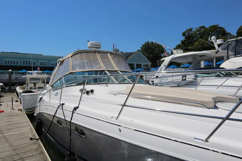 Slide: The Image of 2005 Four Winns 348 Vista yacht docked at marina under clear blue sky. - 4
