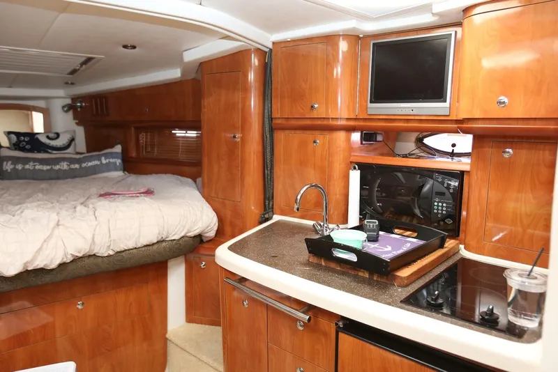 Slide: The Image of Luxurious 2005 Four Winns 348 Vista yacht interior with cozy bed and modern kitchenette. - 40
