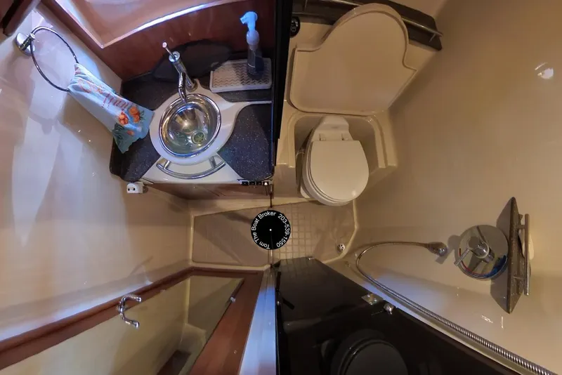 Slide: The Image of Compact bathroom in 2005 Four Winns 348 Vista boat with sink, toilet, and shower. - 45