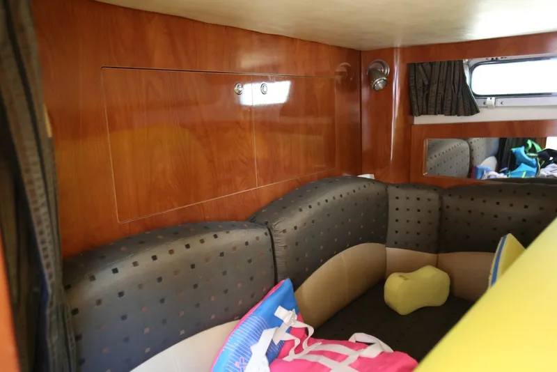 Slide: The Image of Interior of 2005 Four Winns 348 Vista boat with cozy seating and wooden paneling. - 46