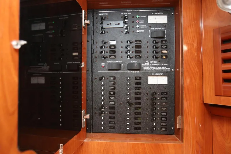 Slide: The Image of Electrical control panel inside a 2005 Four Winns 348 Vista boat. - 49