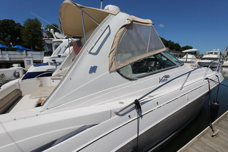 Slide: The Image of 2005 Four Winns 348 Vista yacht docked at marina under clear blue sky. - 5
