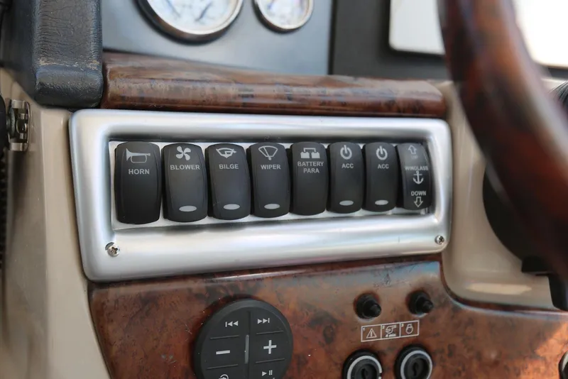 Slide: The Image of Control panel of a 2005 Four Winns 348 Vista boat with labeled switches. - 51