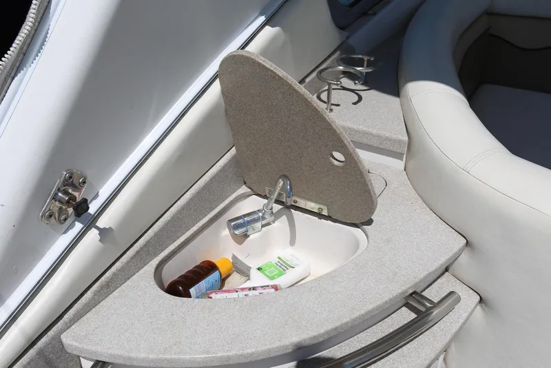Slide: The Image of 2005 Four Winns 348 Vista boat sink with toiletries and cup holders. - 57