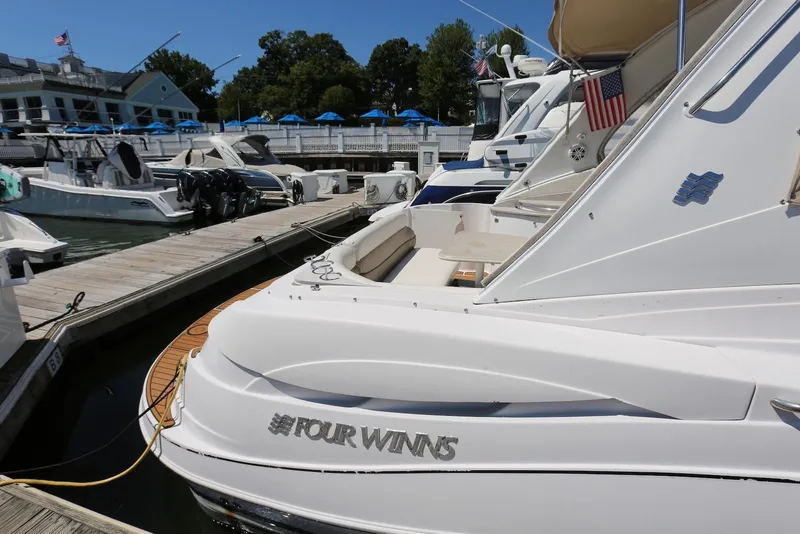 Slide: The Image of 2005 Four Winns 348 Vista yacht docked at marina with American flag. - 6