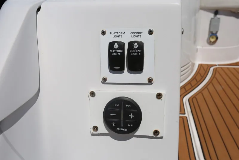 Slide: The Image of Control panel on 2005 Four Winns 348 Vista boat with light switches and audio controls. - 60