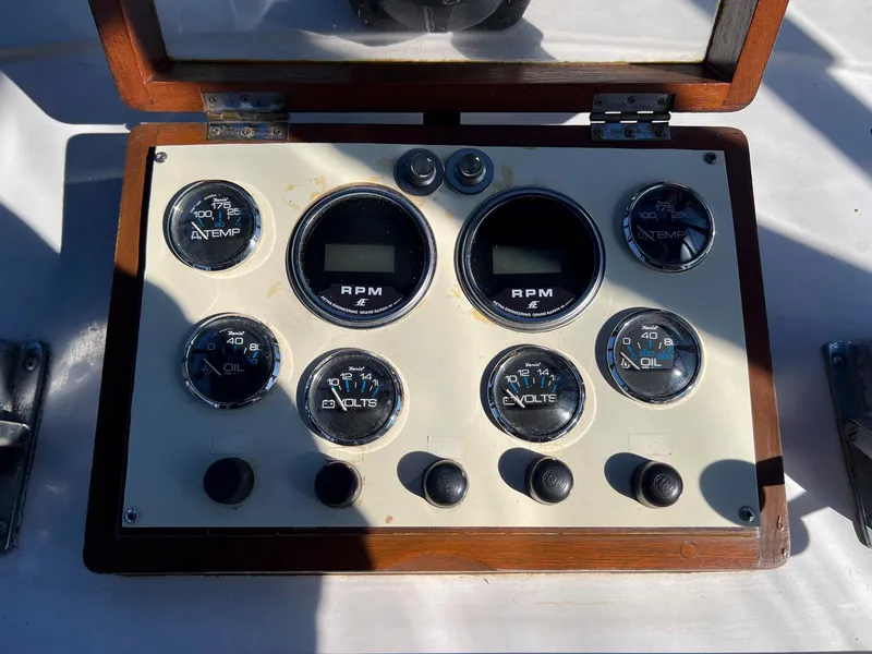 Slide: The Image of Instrument panel of a 1983 Lindmark 39 Trawler with RPM, temperature, and oil gauges. - 17